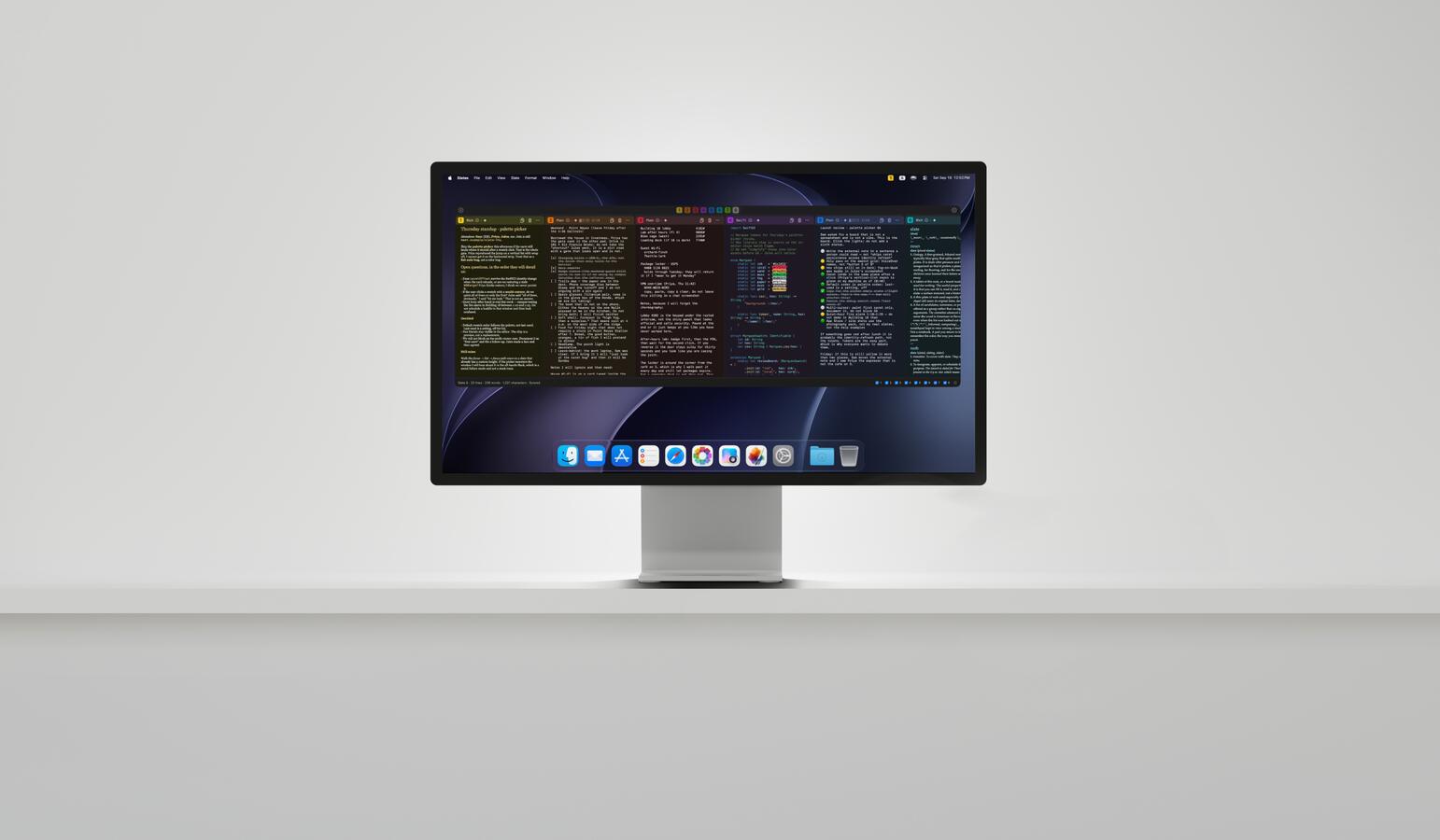 A Studio Display on a pale gray surface, Slates stretched across it as a horizontal strip in Dark.